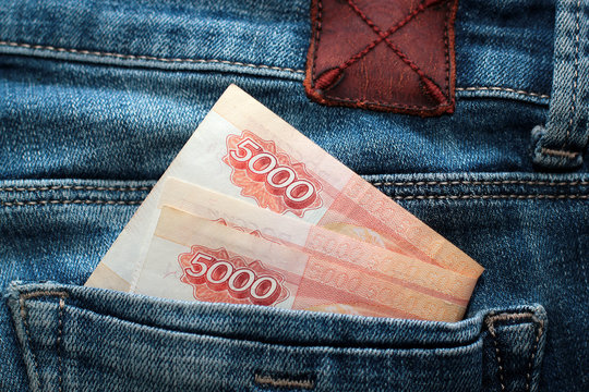 Russian money roubles in blue jeans pocket as a top view image