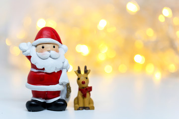 Santa Claus doll on bokeh background for celebration Christmas Eve.Happy New Year