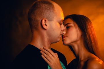 Girl and boy on the background of a sunset color