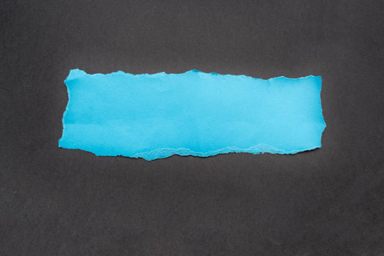 blue rip paper isolated on black background with space for text