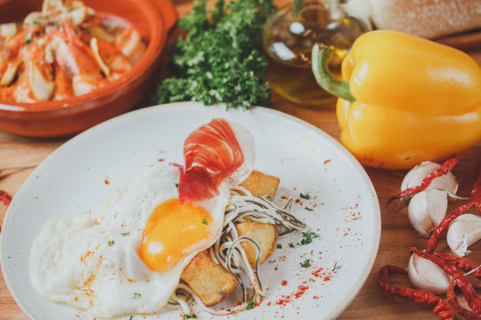 Ham with egg fried and potato deep fried. Spanish breakfast cuisine.