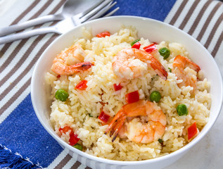 Sticky Fried Rice with Shrimp, Bell Peppers and Green Peas Served in a White Bowl.