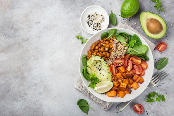 healhty vegan lunch bowl. Avocado, quinoa, sweet potato, tomato, spinach and chickpeas vegetables salad - 183304751