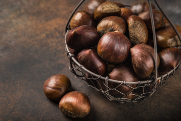 fresh raw  chestnuts on brown  background