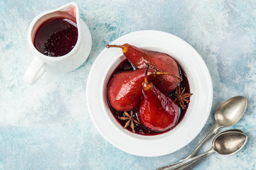 delicious red wine poached pears in spicy syrup - obrazy, fototapety, plakaty