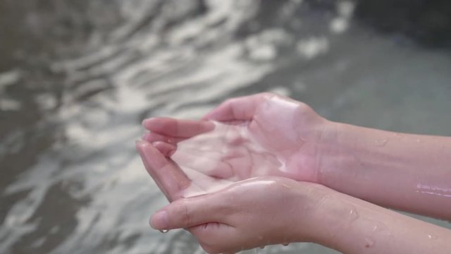 girl hand bail scoop of clean water