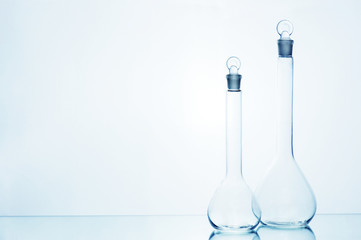 Two empty medicine transparent glass bottles on the mirror table