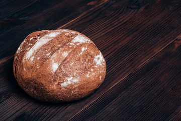 Freshly baked bread on a brown wooden table
