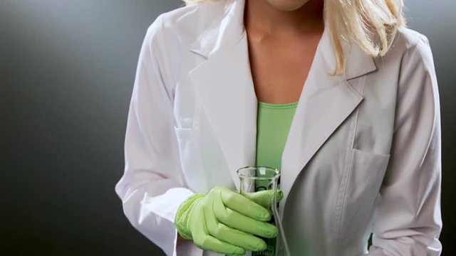 Woman looking down at partially empty beaker