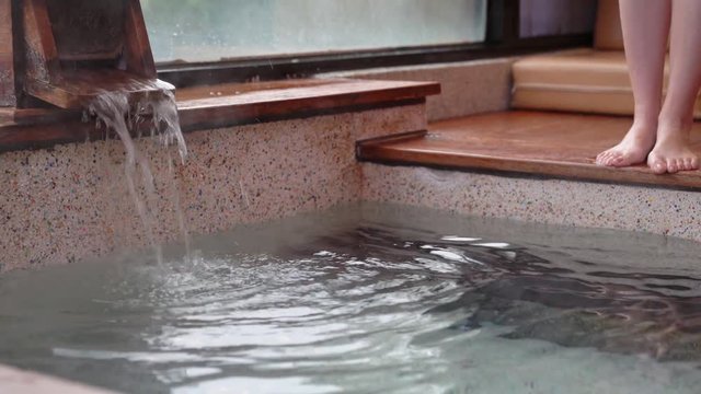 young girl walking into hot springs bath