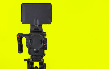 Professional video camera on vivid color background making contrast