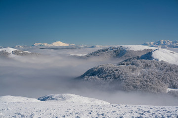 view of the mountain peaks above the clouds