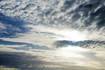 Fluffy white clouds against a blue sky on a sunny summer day.