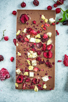 Milk chocolate bar with dried berry fruits and almonds
