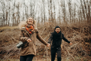 Outdoor shot of young couple enjoying on their hiking trip. Young boy and girl having fun outdoor