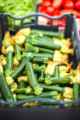 Fresh organic Zucchini with zucchini flowers at outdoor farmers  market. Healthy local food market concept
