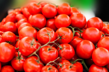 Close up of fresh organic tomatos at outdoor farmers  market. Healthy local food market concept. Variety of tomatoes in a box.