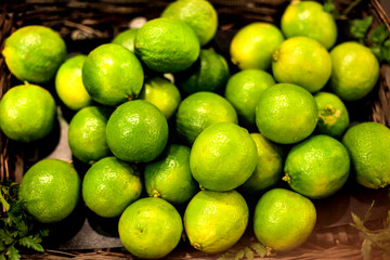 Organic pile of green Limes on  a local farmer market. Healthy local food market concept  in vintage hipster style.