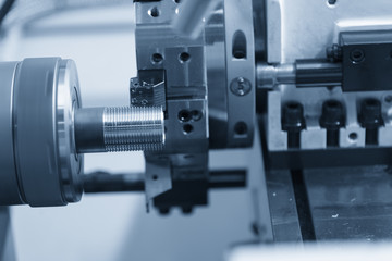 CNC lathe machine (Turning machine) cutting the metal  screw thread tube part.Thread machining process.