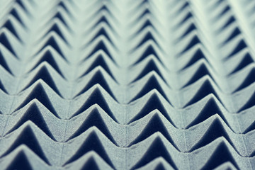 Acoustic foam panel background, blue toned image, shallow depth of field