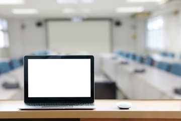 blank screen laptop on the desk on background meeting room