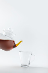 full teapot with cup isolated on white