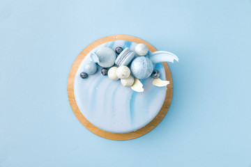 top view of blue tasty cake isolated on blue