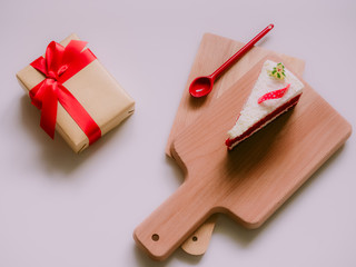 minimal flat lay concept for christmas and new year event by gift box and white cake on wooden chopping board arrange on table with isolated background