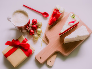 minimal flat lay concept for christmas and new year event by coffee cup ,strawberry and coconut cake on wooden chopping board arrange on table with isolated background