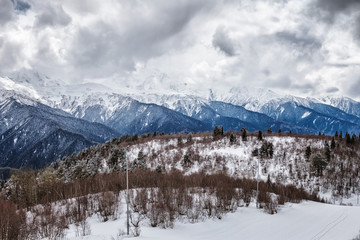 Fototapeta na wymiar Panoramic view on snow winter mountains and cloud sky. Caucasus Mountains. Svaneti region of Georgia.