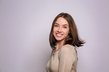 Beautiful smiling woman on light background