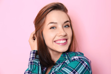 Fototapeta premium Beautiful smiling woman on color background