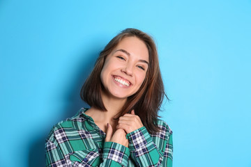 Fototapeta premium Beautiful smiling woman on color background