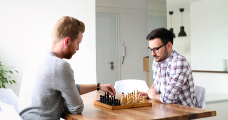 Portrait of two young man playing chess