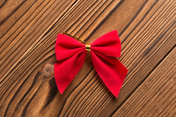 red bow on a wood background