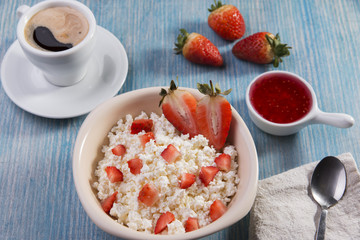 cottage cheese with pieces of strawberries jam and coffee breakfast