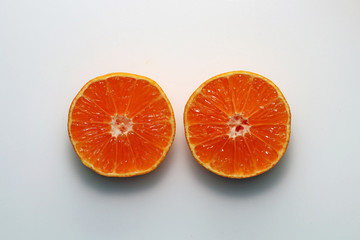 Two halves of mandarin isolated on white background