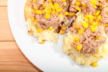 Tuna and sweetcorn topping on mashed baked potato. Close-up from above.
