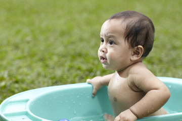 baby taking bath outdoor