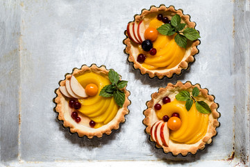 healthy food is fresh fruits and berries, peaches, apples, cranberries, Cape gooseberries in a basket from dough of whole wheat flour