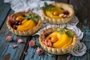 healthy food is fresh fruits and berries, peaches, apples, cranberries, Cape gooseberries in a basket from dough of whole wheat flour