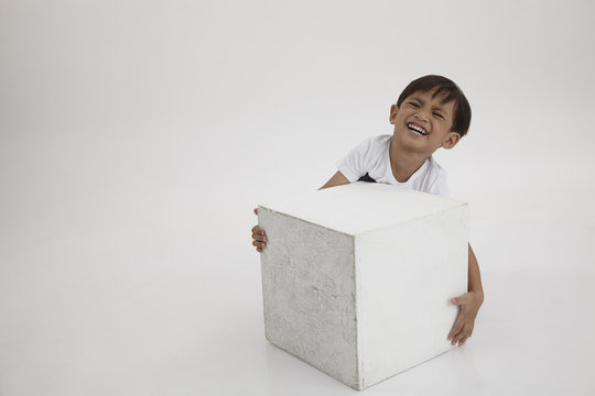 Boy Lifting A Box