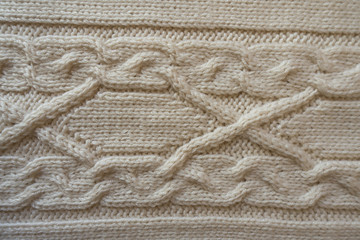 Beige handmade textile with horizontal cable knit pattern from above