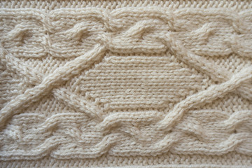 White handmade knitwork with horizontal braid pattern from above