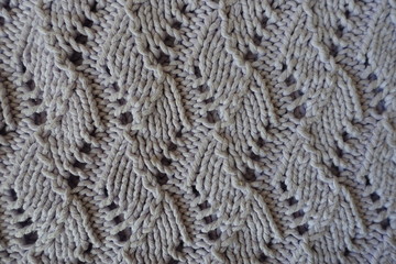 Relief pattern with perforations on handmade gray knitwork