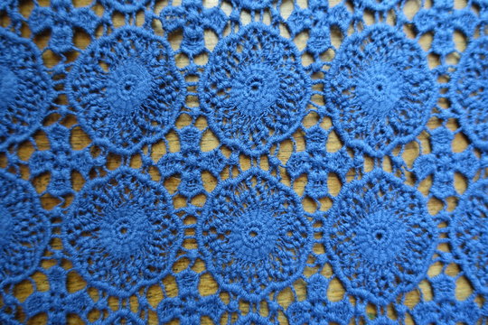 Old fashioned lacy fabric on wood from above