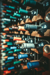 Many dusty wine bottles are on the shelves,Racks of wine bottles