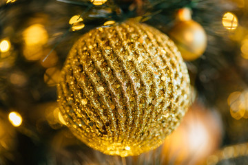 Golden christmas ball Decorated and illuminated tree
