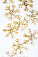 Brown snowflakes on a wooden background.