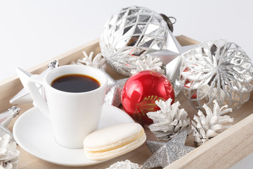Christmas decoration and small cup of coffee on white